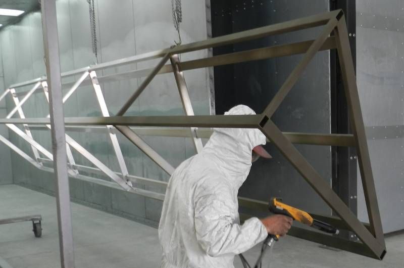 Parasol Awnings employee in the powder coat spray booth