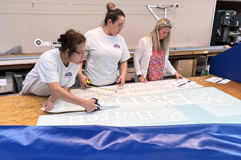 Sewing techs at work on awning graphics