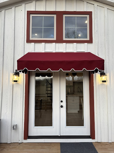 burgundy awning with scalloped valance over residential door