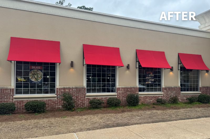 concave fabric awnings in Jockey red over windows