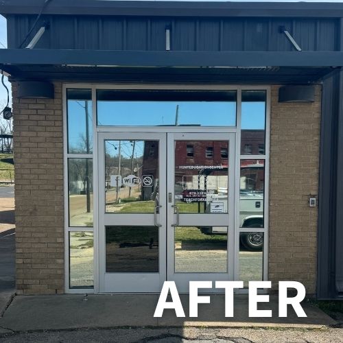 grey metal suspended canopy awning over glass entry doors